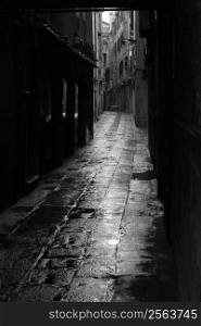 Dark alley in the rainy streets of Venice, Italy.