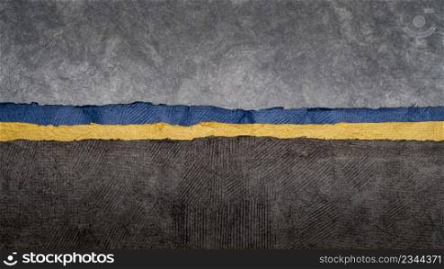 dark and gloomy landscape abstract with a narrow band of Ukraine blue and yellow colors. collection of handmade bark papers
