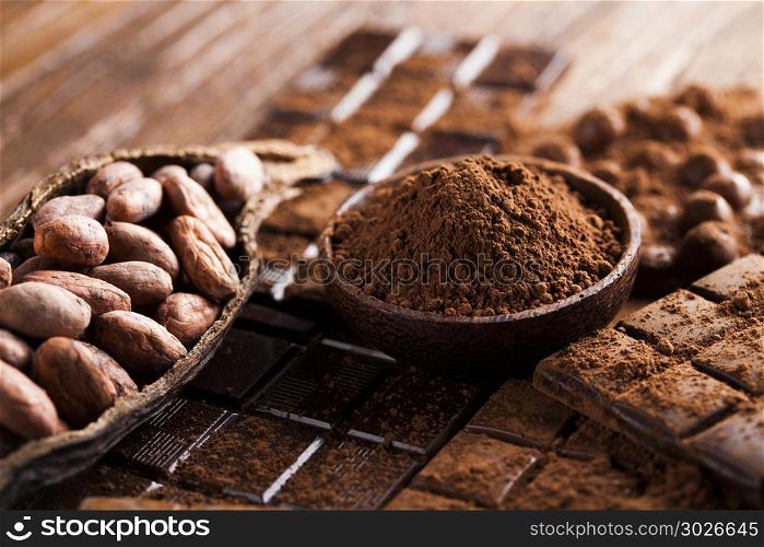 Dark and milk chocolate bar on a wooden table . Chocolate sweet, cocoa and food dessert background