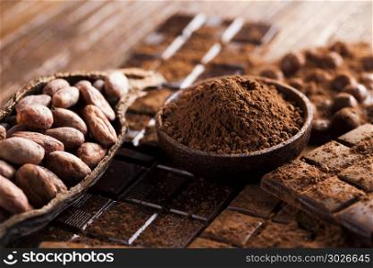 Dark and milk chocolate bar on a wooden table . Chocolate sweet, cocoa and food dessert background