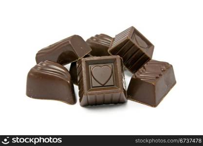 dark assorted chocolate pralines on white background