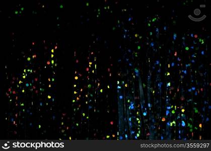 Dark background with bright multicolored shiny patterns