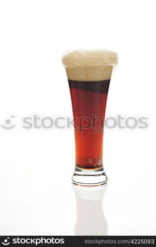 dark beer with the foam in a tall glass isolated on white