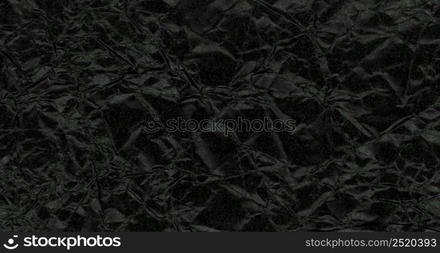 dark black crumpled paper texture useful as a background. dark black crumpled paper texture background
