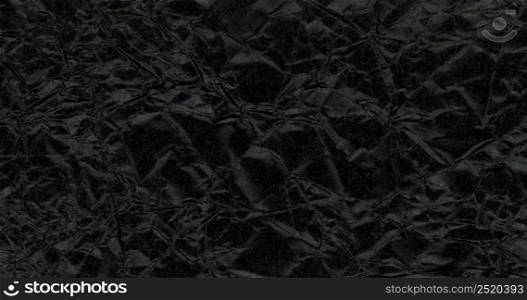 dark black crumpled paper texture useful as a background. dark black crumpled paper texture background