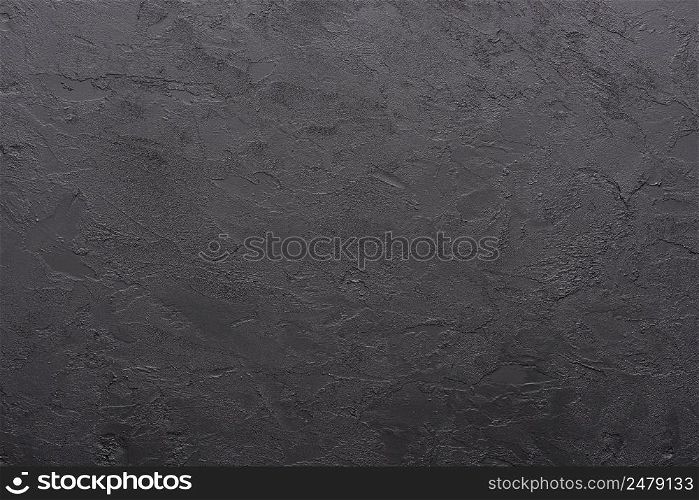 Dark black painted stucco background texture