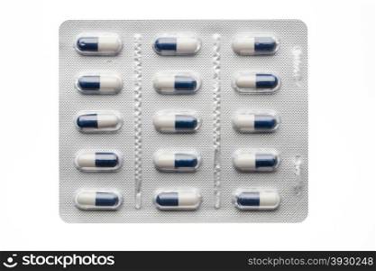 Dark blue capsules in blister pack closeup isolated. Dark blues capsules in blister pack closeup isolated on white background
