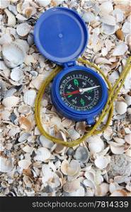 Dark blue compass on sand