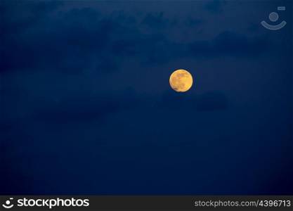 Dark blue sky with full moon and mistery clouds