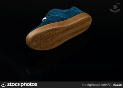 dark blue velvet man&rsquo;s shoe on black background