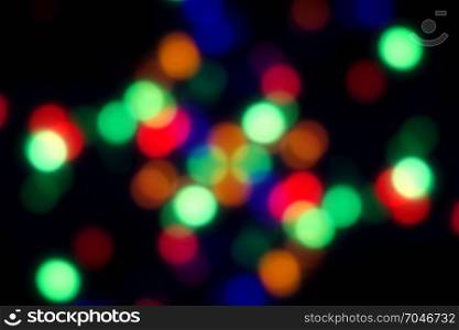 Dark blurred background with yellow, orange and red spots