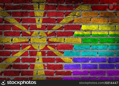Dark brick wall texture - coutry flag and rainbow flag painted on wall - Macedonia