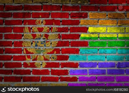 Dark brick wall texture - coutry flag and rainbow flag painted on wall - Montenegro