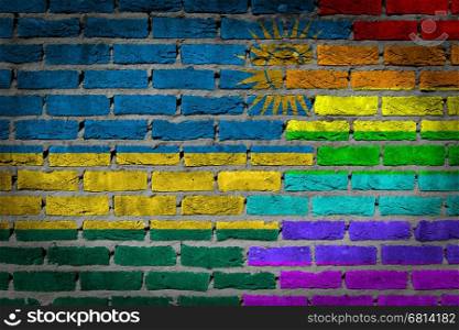 Dark brick wall texture - coutry flag and rainbow flag painted on wall - Rwanda