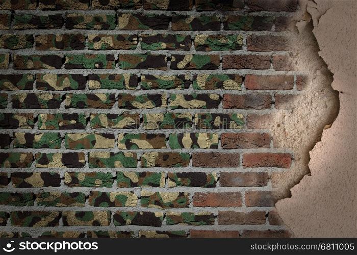 Dark brick wall texture with plaster - flag painted on wall - Army camouflage