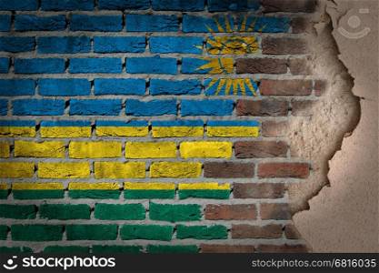 Dark brick wall texture with plaster - flag painted on wall - Rwanda