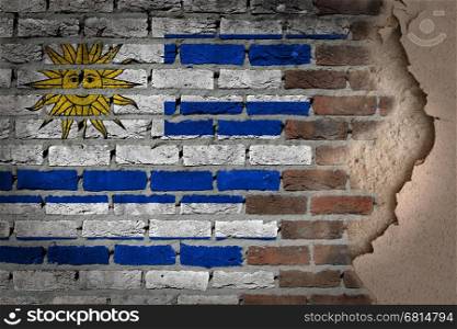 Dark brick wall texture with plaster - flag painted on wall - Uruguay