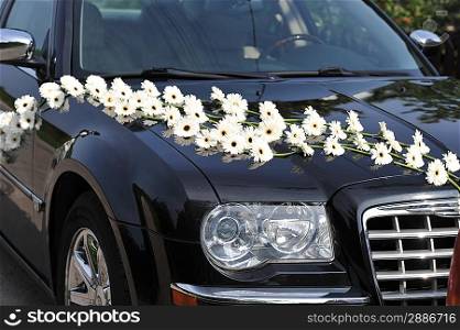 dark car decorated with white flowers