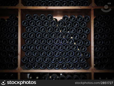 Dark cellar with old bottles of red wine