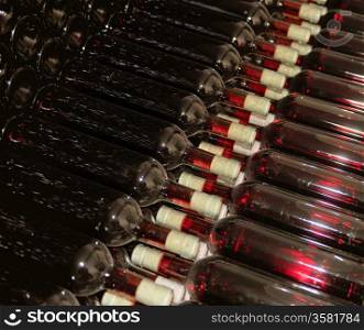 Dark cellar with old bottles of red wine