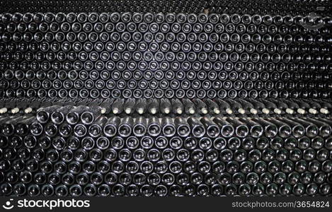 Dark cellar with old bottles of red wine