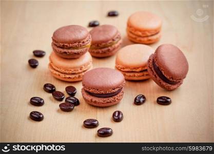 dark chocolate and caramel macaroons on wooden table