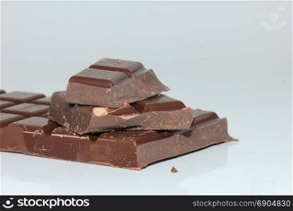 Dark chocolate bar , broken in oneven pieces