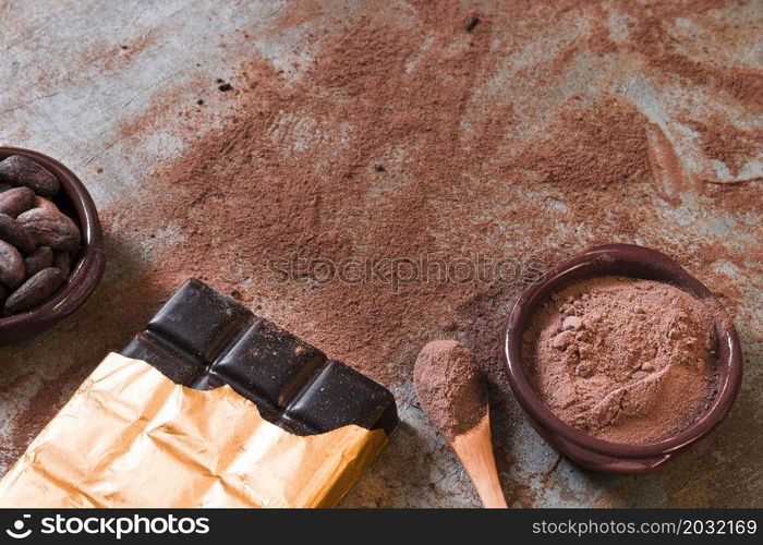 dark chocolate bar with scattered cocoa powder beans bowl rustic backdrop