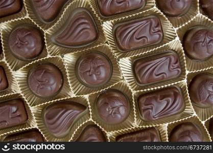 dark chocolate pralines in a golden box
