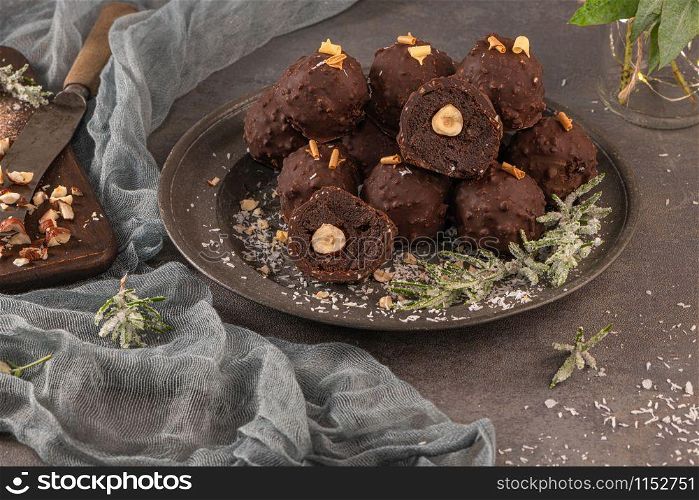 Dark chocolate truffles with hazelnuts on plate