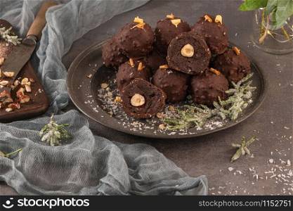 Dark chocolate truffles with hazelnuts on plate