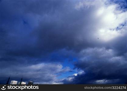 Dark Clouds In The Blue Sky Over A City