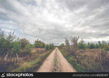 Dark clouds over a countryside trail in the fall