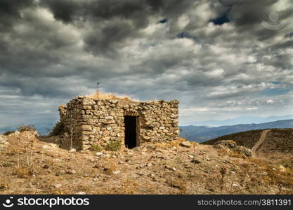 Dark clouds over an old bergerie in the hills near Col de San Colombanu in the Balagne region of Corsica