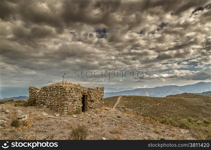 Dark clouds over an old bergerie in the hills near Col de San Colombanu in the Balagne region of Corsica