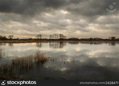 Dark clouds over the frozen lake, Stankow, Poland