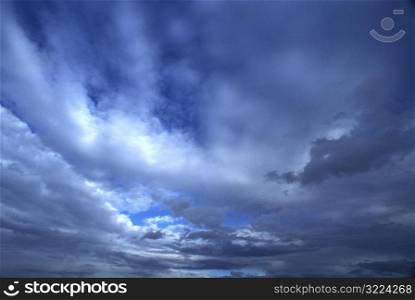 Dark Clouds Streaking Through A Blue Sky
