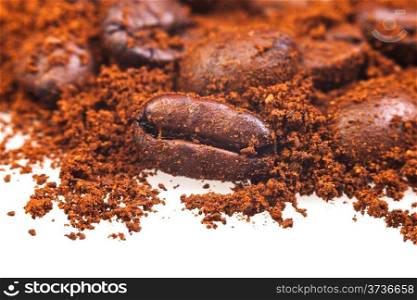 dark coffee beans in ground coffee close up
