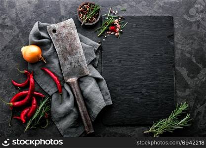 dark culinary background with empty black slate board and space for text recipe or meat menu
