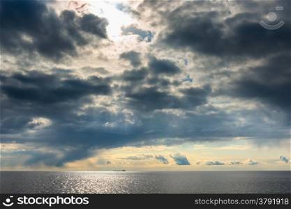 dark cumulus clouds hovering over the sea