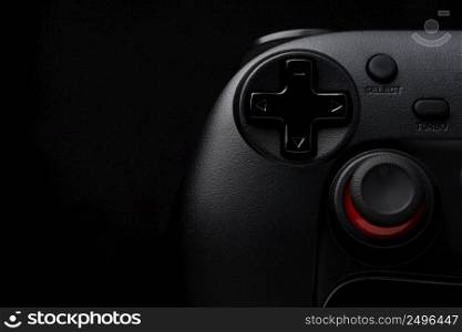 Dark game pad video game controller joy stick on black background with copy space