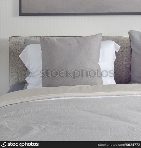 Dark gray pillow with comfy bed and black shade reading lamp