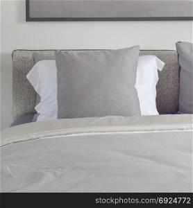 Dark gray pillow with comfy bed and black shade reading lamp