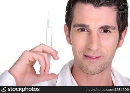 dark-haired man holding syringe