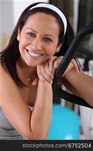 dark-haired woman posing in gym