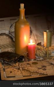 Dark image Old map, a candle and the rope and Bottle