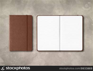 Dark leather closed and open lined notebooks mockup isolated on concrete background. Dark leather closed and open lined notebooks on concrete background