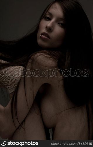 dark moody picture of beautiful naked woman.
