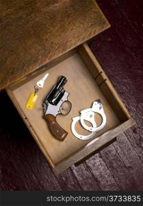 Dark Office and 38 Revolver in Desk Drawer with Handcuffs