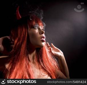 dark picture of smoking naked devil woman
